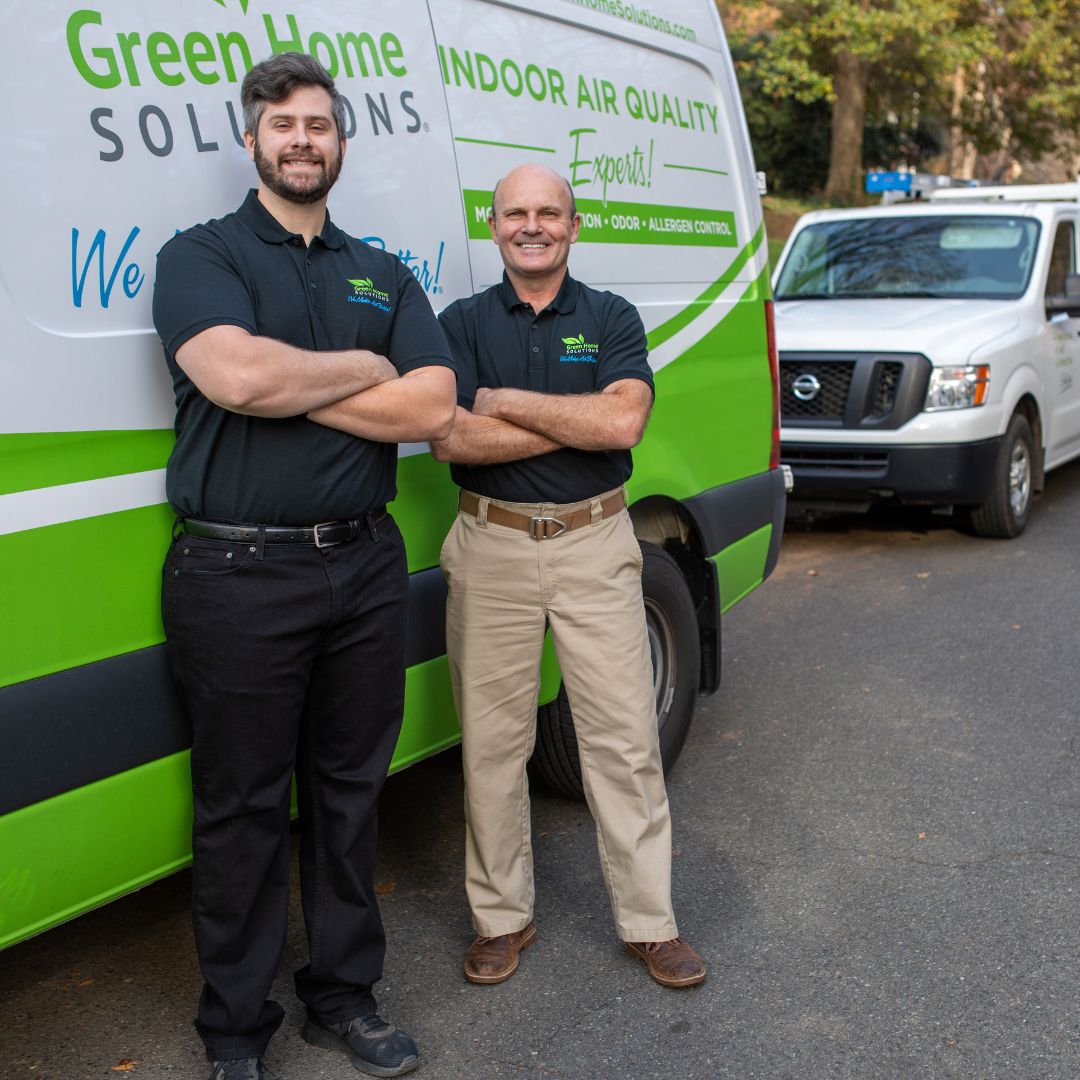 green-home-solutions-duct-cleaning-services two men in black polo shirts standing in front of a van
