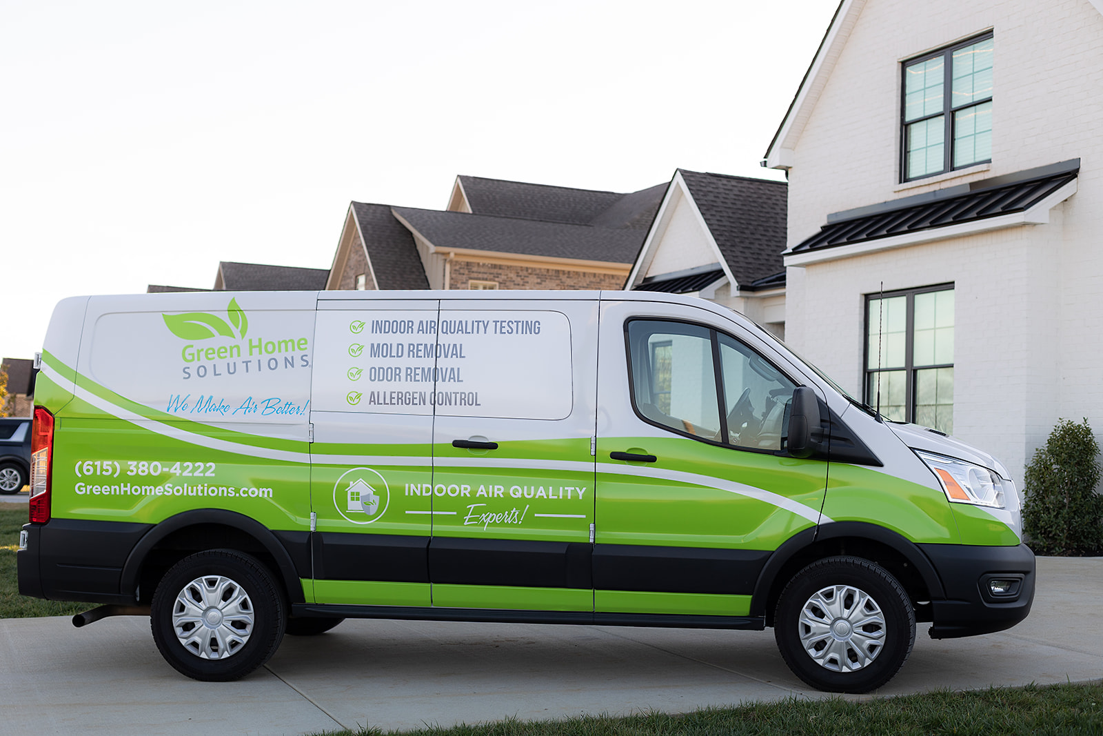 green and white van parked in a driveway