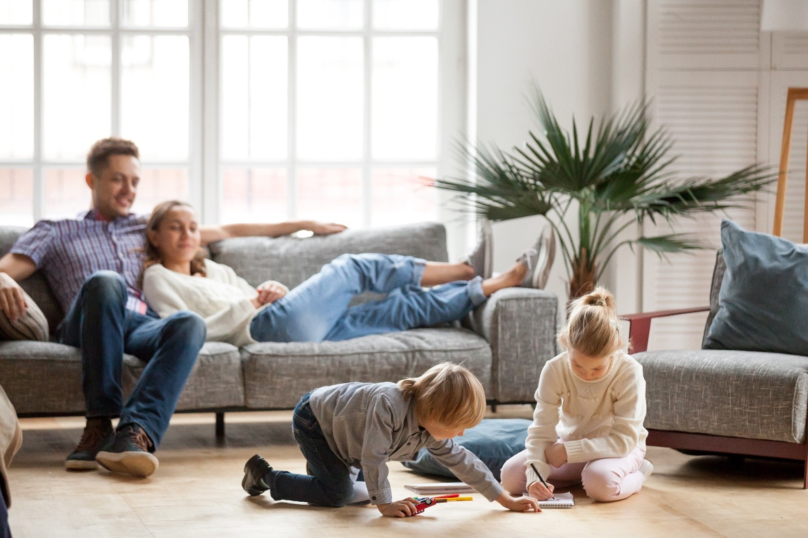 business-06 A family sitting in the living room together.