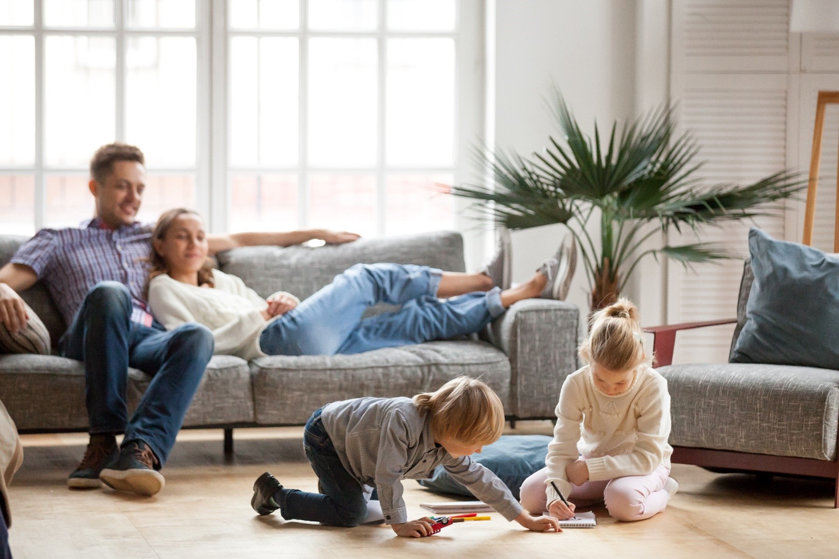 A family of four in the living room. 