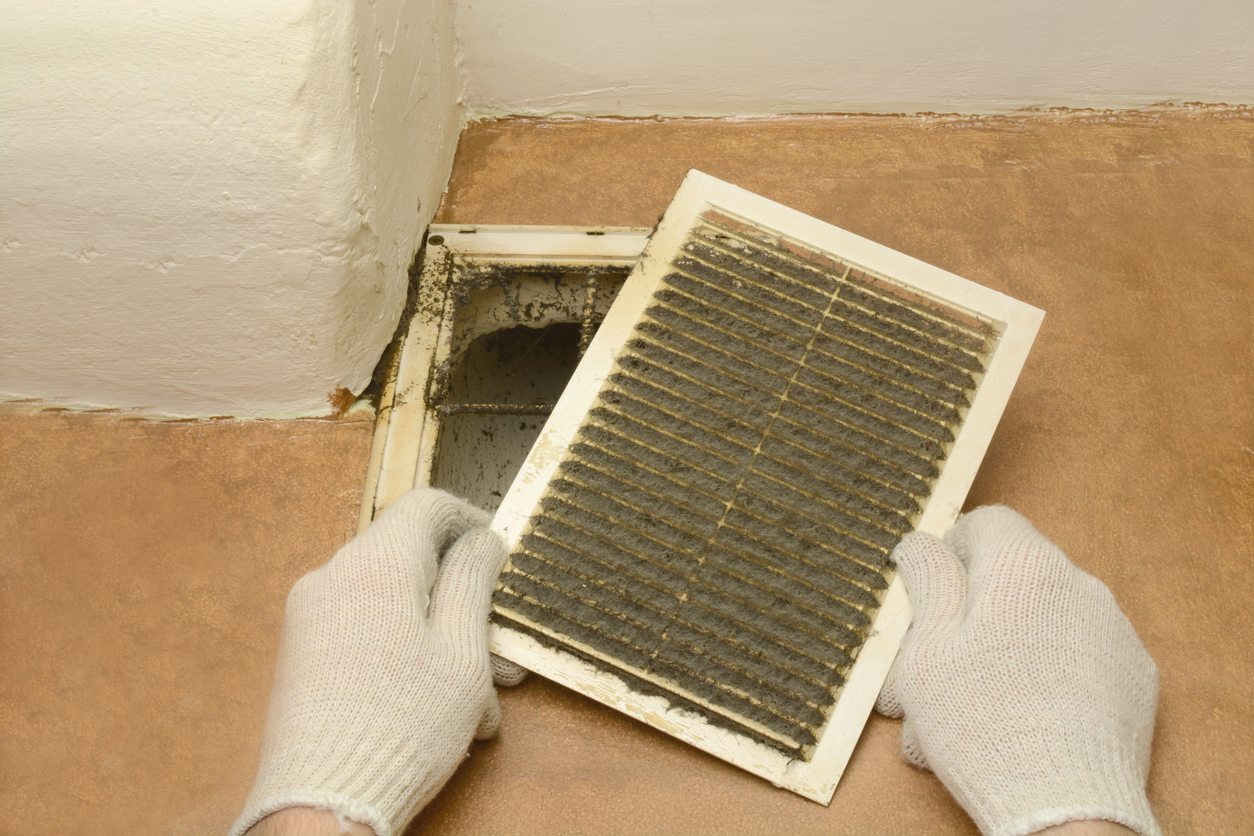professional-air-duct-cleaning-services man removes dust ventilation grilles