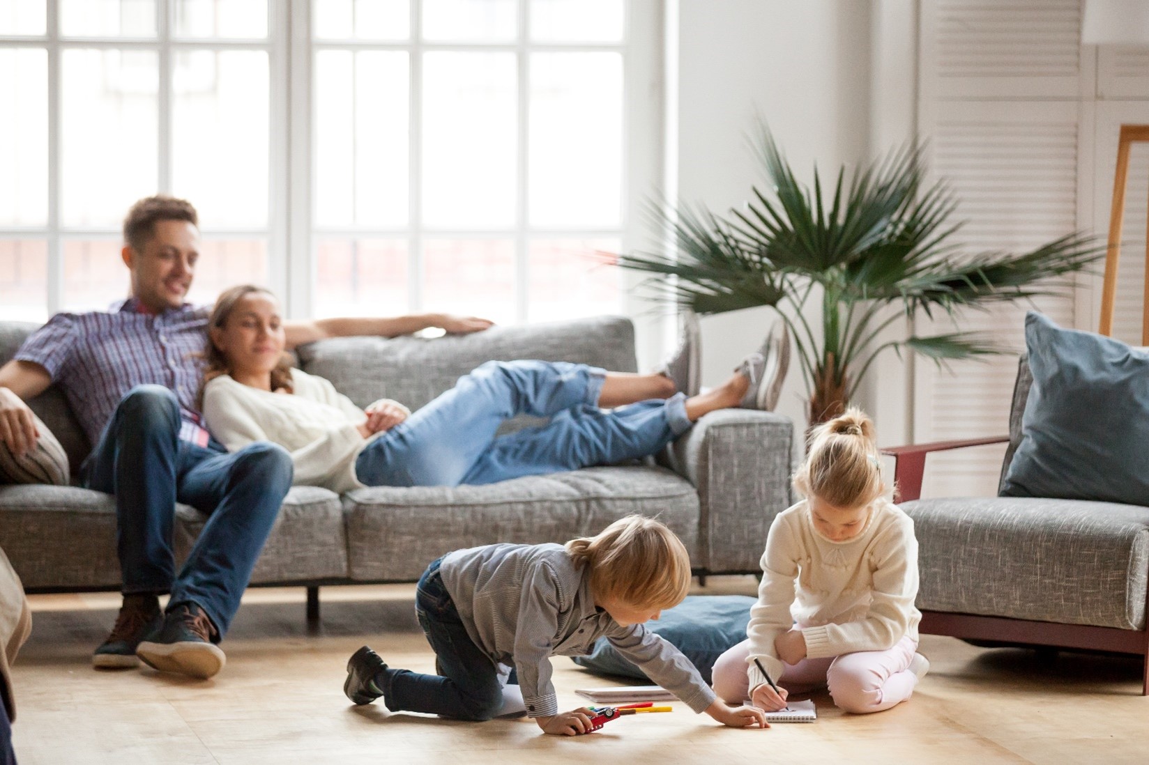 A family relaxing in a living room together.