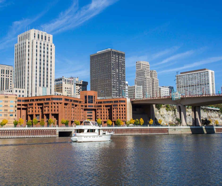 Skyline of downtown St. Paul, MN with water in the foreground and a boat