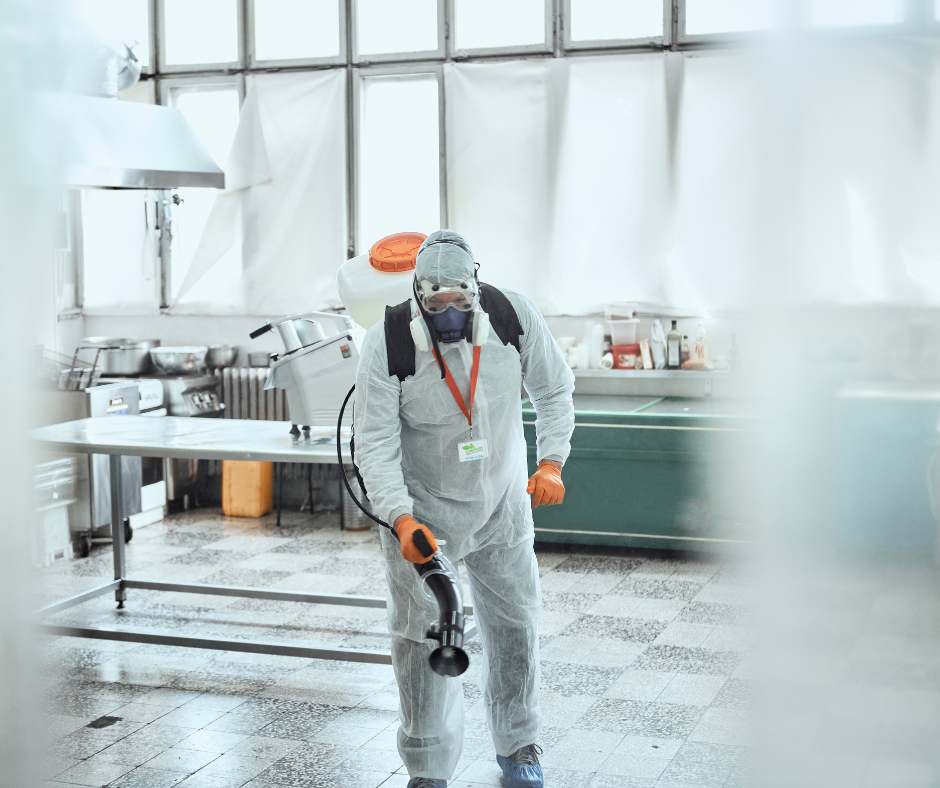 Two Green Home Solutions Employees in PPE Standing in Front of a GHS Van with a Disinfection Treatment Fog Machine Between Them