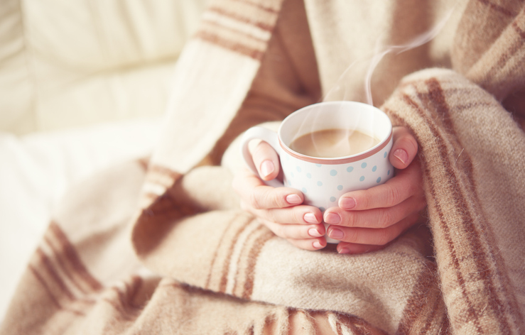 fall-indoor-air-quality-tips-green-home-solutions warm cup of hot coffee warming in the hands of a girl